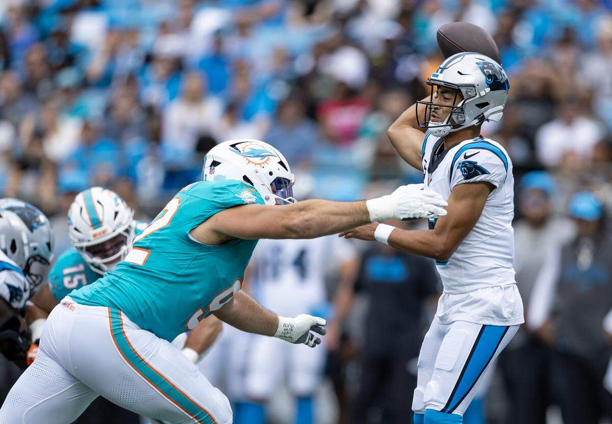 Miami Dolphins defensive tackle Zach Sieler (92) pressures Carolina Panthers quarterback Bryce Young (9) during the first half of an NFL game at Bank of America Stadium on Sunday, Oct. 5, 2025, in Charlotte, N.C.