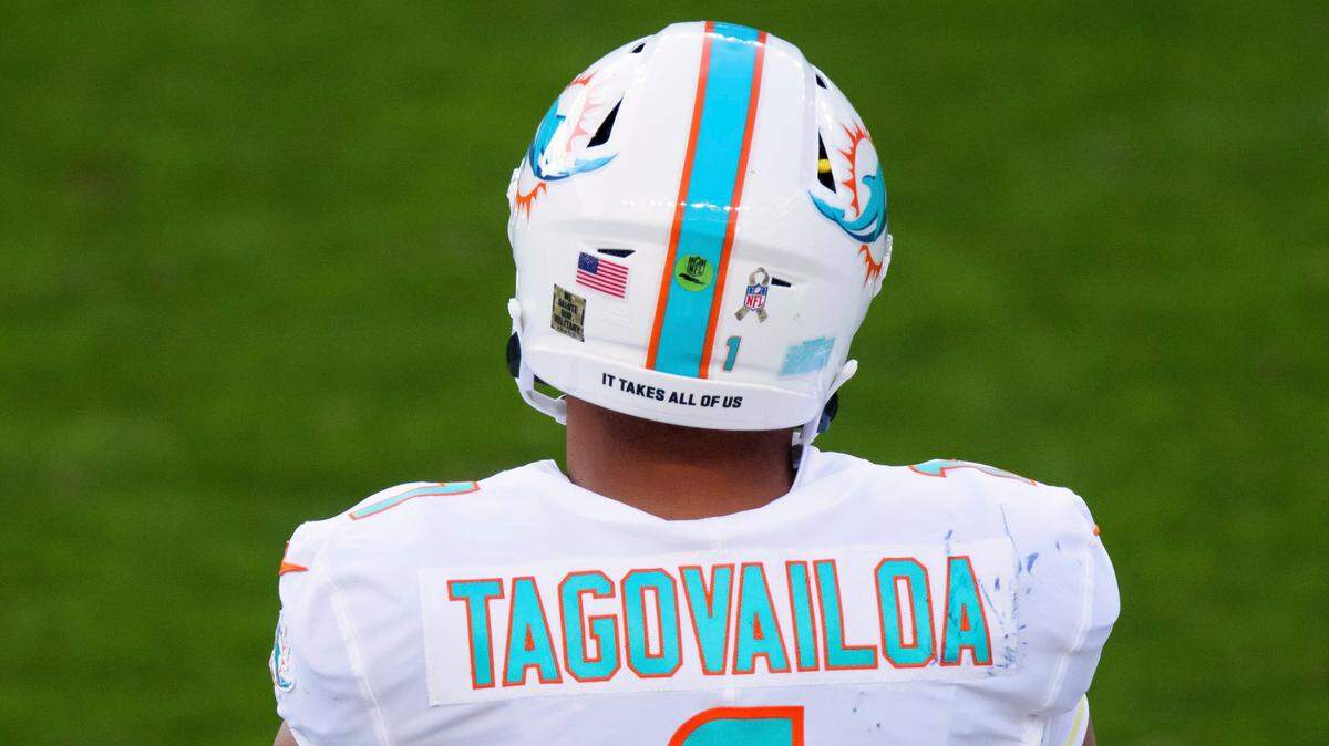 Miami Dolphins quarterback Tua Tagovailoa (1) wears a halt sticker that reads “It Takes All Of Us” against the Denver Broncos during the first half of an an NFL football game, Sunday, Nov.. 22, 2020, in Denver.