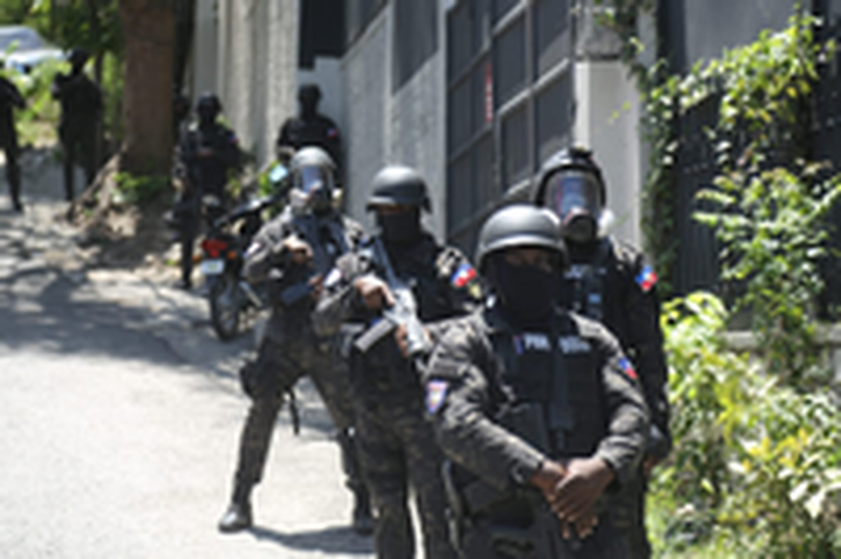 Police watch as thousands of Haitians take to the streets of Port-au-Prince on Wednesday, April 2, 2025 to protest against armed gangs and demand the resignation of Haiti’s transitional authorities