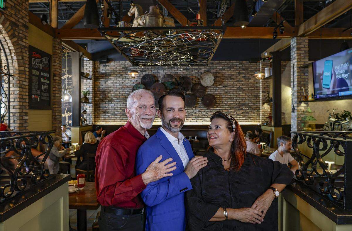 CEO of Sergio's Family Restaurants, Carlos Gazitua, at center, with his father John Gazitua, and mother Blanca Cabrera, at Sergio's in Kendall, as the local restaurant chain celebrates it's 50th Anniversary in Miami, Florida, on Wednesday, September 24, 2025.