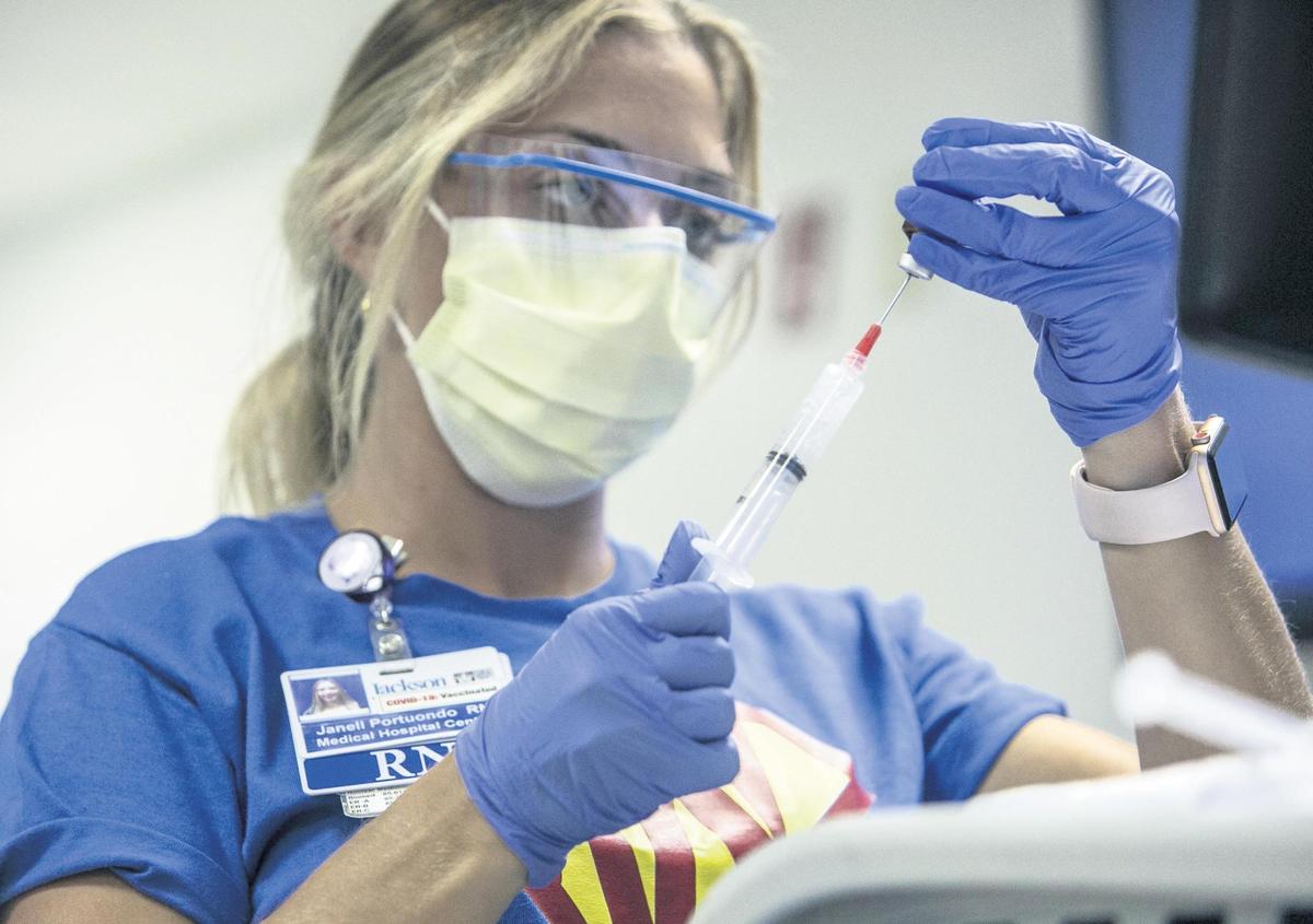  A nurse prepares medication to be administered to a COVID-19 patient in the Medical Intensive Care Unit on Friday, July 23, 2021, at Jackson Memorial Hospital in Miami. 