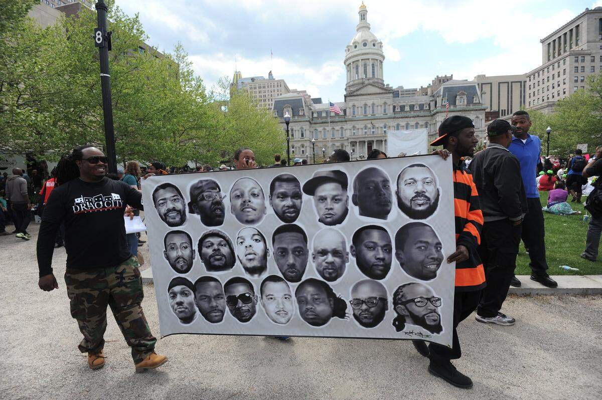 Donta Bowden, left, and Robert Kirby, III demonstrate at War Memorial Plaza in Baltimore on Saturday, May 2, 2015, as protests continue in the wake of the death of Freddie Gray. (Kim Hairston/Baltimore Sun/TNS)