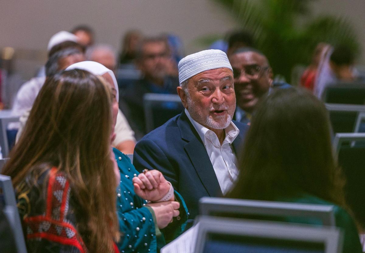 Iman Dr. Abdul Hamid Samra, speaks with with attendees during the Florida International University iftan dinner.