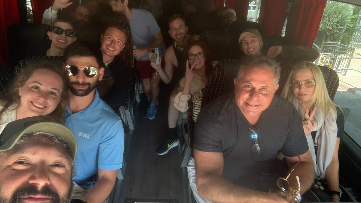 Grey Bull Rescue founder Bryan Stern, wearing a hat in the lower left hand side, takes a photo with the first group his organization evacuated from Israel as tensions mount with Iran in June 2025.