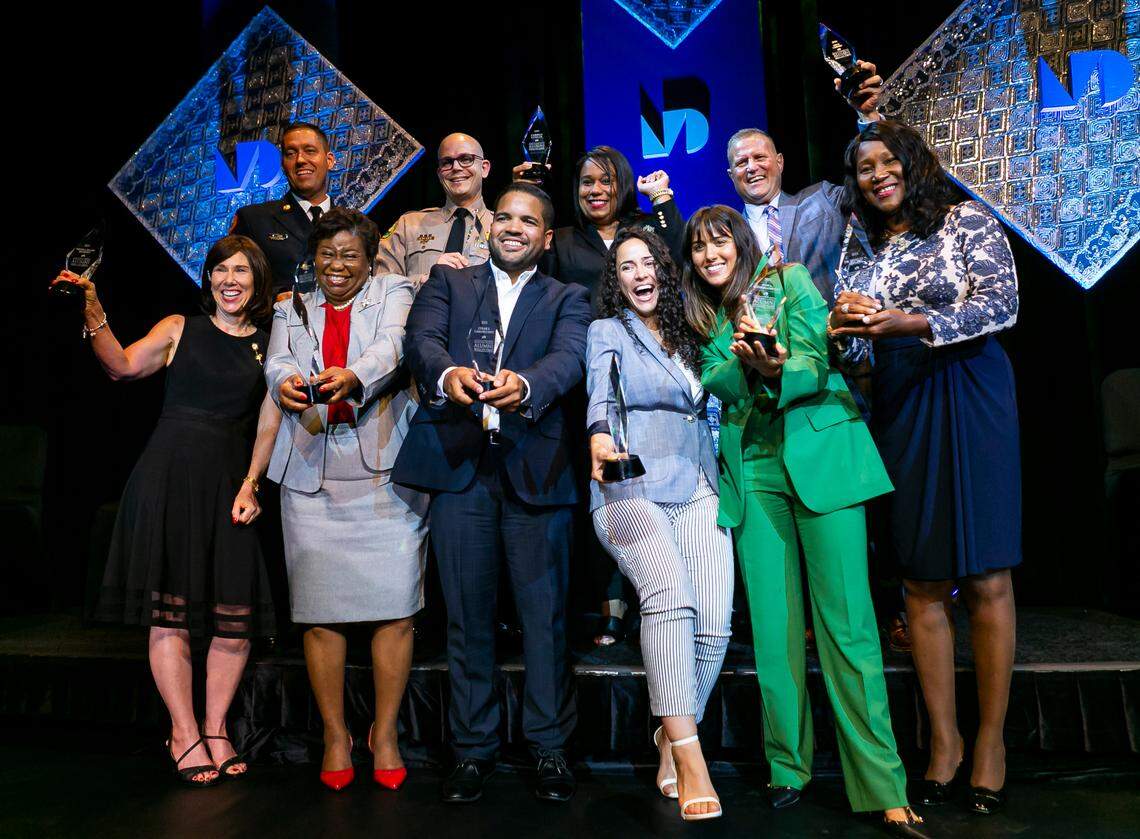 From left to right: Teresa Ellen Murphy, Brandon Webb, Sheila Jones-Coakley, Brian Rafky, Cesar F. Larancuent, Caridad Cuellar, Betsy Godoy-Rosado, Jessica Gutierrez-Castillo, Pete Gomez and Shirley N. Codada celebrate after being inducted in Miami Dade College’s Alumni Hall of Fame at the school’s Wolfson Campus in downtown Miami on Wednesday, June 9, 2021. MDC recognized ten alumni on the frontlines of the coronavirus pandemic in a special heroes edition of the annual Alumni Hall of Fame induction ceremony.