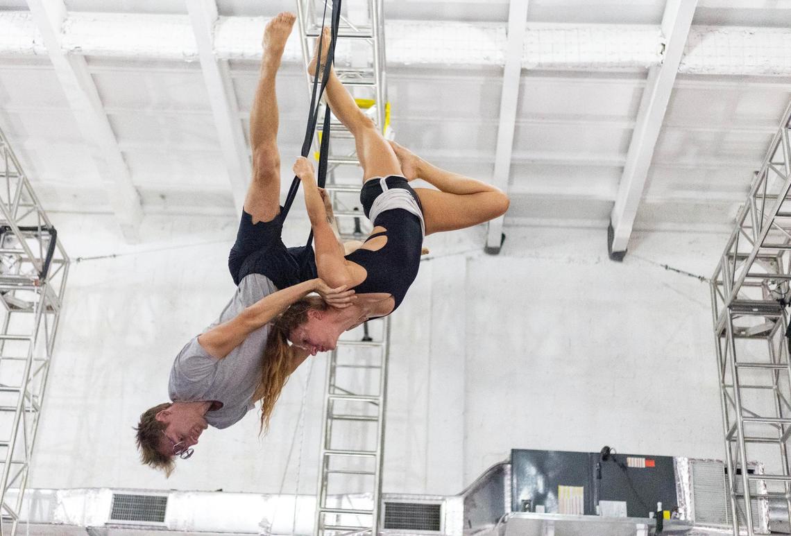 Nicholas Ferri pushes up Mila Puletti’s shoulders as she does the bird’s nest pose while training on the straps at the Miami Circus Arts Center on July 12, 2023, in Miami, Fla. Puletti’s main goal is to perform more often.