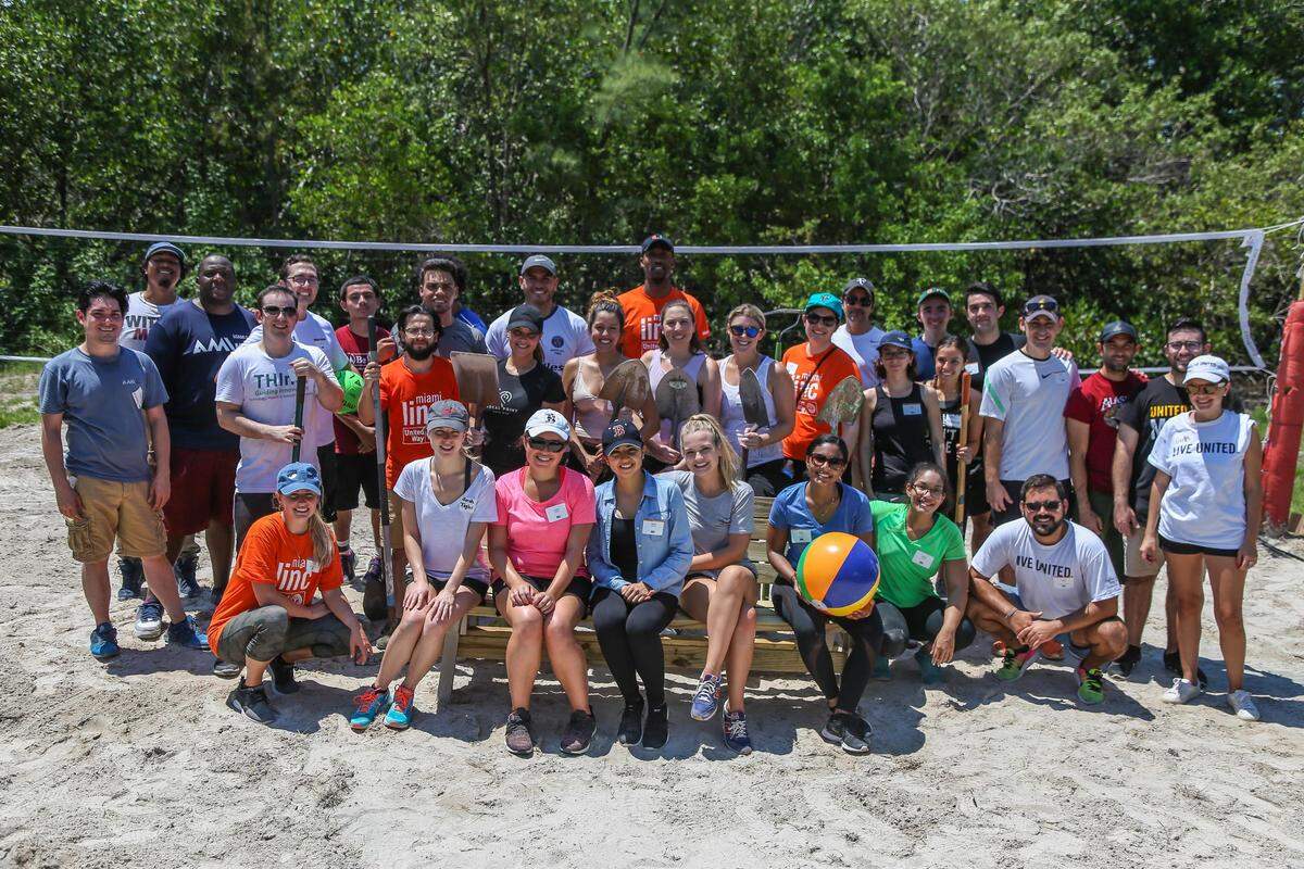 Volunteers ages 22 to 30 in the United Way’s LINC program have a passion for serving their community. Here they celebrate their latest project renovating a beach volleyball court and building benches at the AMIkids Miami-Dade South in Key Biscayne.