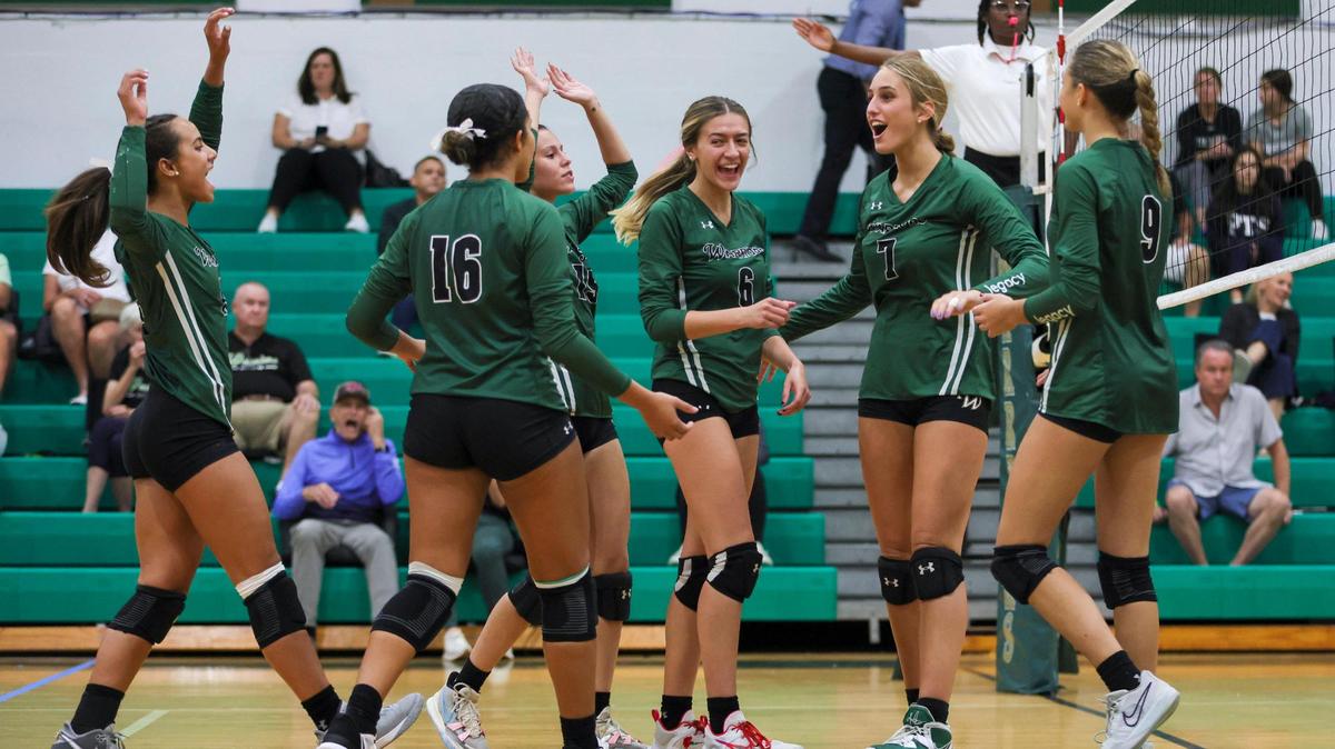 Westminster Christian Warriors players celebrate against the Palmer Trinity Falcons during the first set of a volleyball Region 4-3A quarterfinal playoff match at Westminster Christian School in Palmetto Bay, Florida, Tuesday, October 24, 2023.