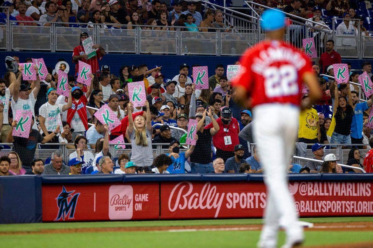 Miami Marlins fans in the ‘Sandy’s Beach’ zone react to pitcher Sandy Alcantara (22) after he got a strike for the final out of the eighth inning of an MLB game against the Los Angeles Dodgers at loanDepot park in the Little Havana neighborhood of Miami, Florida, on Saturday, August 27, 2022.