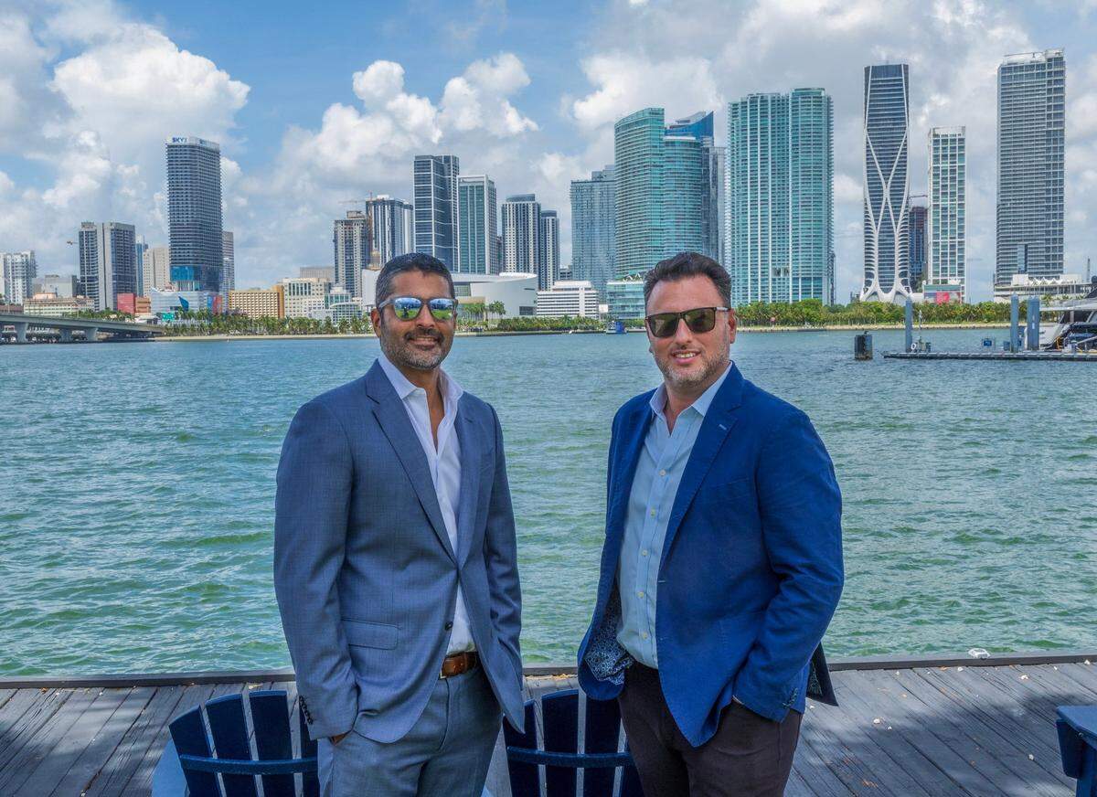 Nitin Motwani and Greg Freedman, principals of BH3 Merrimac, pose for a photo near their planned development site on Watson Island on Wednesday, July 31, 2024.