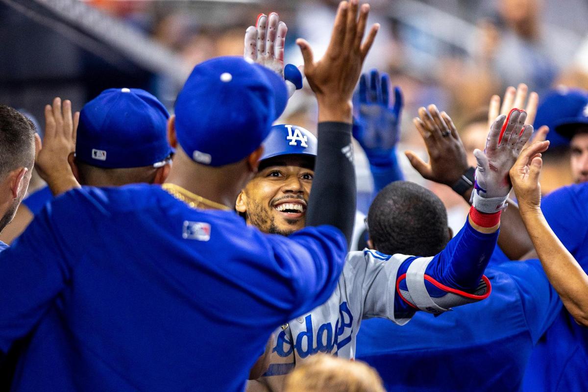 Los Angeles Dodgers base runner Mookie Betts (50) reacts with teammates after hitting a home run during the seventh inning of an MLB game against the Miami Marlins at loanDepot park in the Little Havana neighborhood of Miami, Florida, on Friday, August 26, 2022.