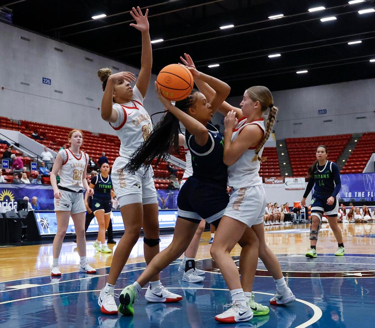 SLAM Miami Titans Taeler Suber (11) battles against Cardinal Mooney under the basket in the second half during girls 3A basketball semifinal game of the Florida High School State Championships at the RP Funding Center in Lakeland, Florida on Friday, February 28, 2025.