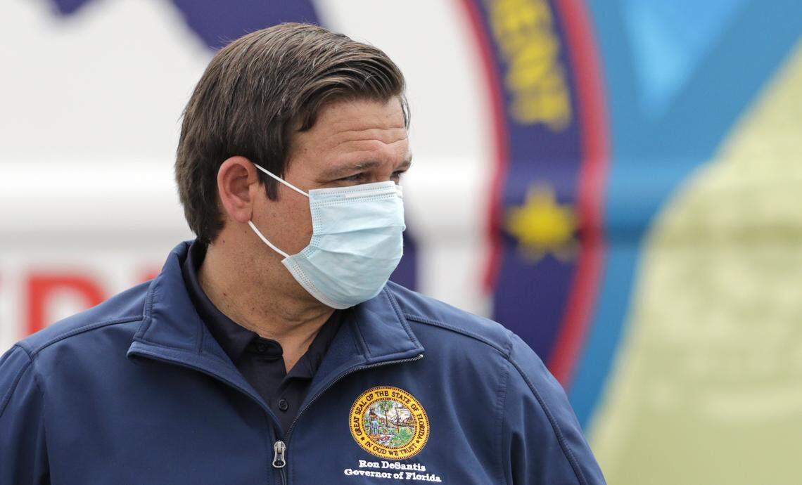 Florida Governor Ron DeSantis looks on as he wears a protective mask during press conference to announces COVID-19 antibody testing, mobile lab at Hard Rock Stadium as the Novel Coronavirus pandemic continues on Wednesday, May 6, 2020 in Miami Gardens.