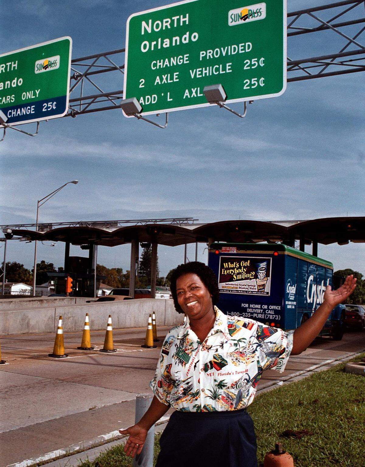 Toll collector Betty Demps at the Hollywood toll plaza models the new uniforms that all the toll collectors will be sporting.
