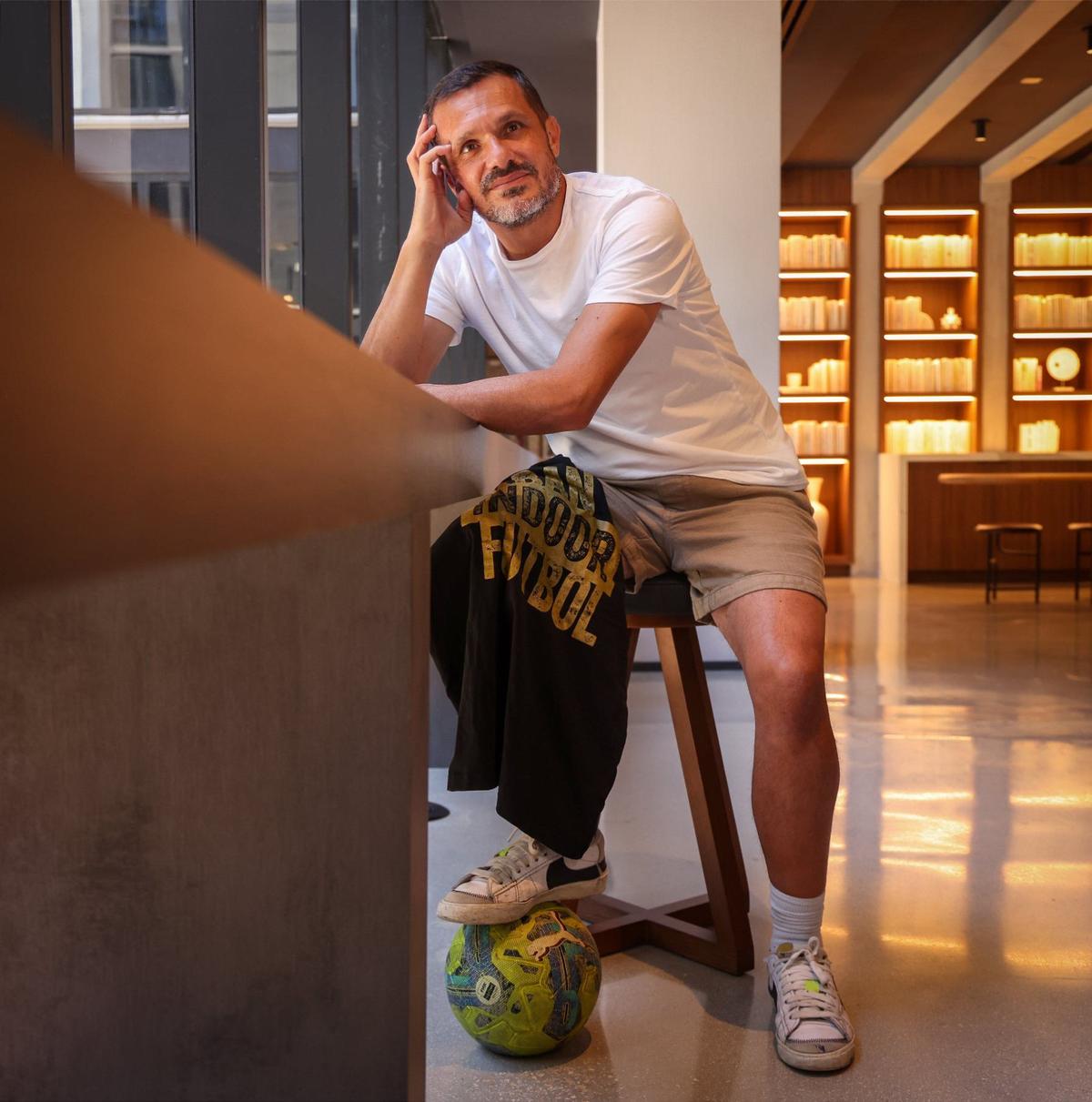 Michael “Mike” Athea, the founder of Urban Indoor Football, sits in the common area of Wynwood Society on Tuesday, May 4, 2024, in Miami, Florida. He is still campaigning to find a location for his soccer club and training facility.