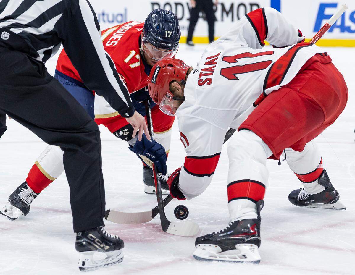 Florida Panthers center Evan Rodrigues (17) and Carolina Hurricanes center Jordan Staal (11) face-off in the second period of Game 4 during the Eastern Conference final of the NHL Stanley Cup playoffs at Amerant Bank Arena on Monday, May 26, 2025, in Sunrise, Fla.
