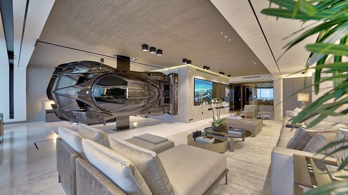 A rare $1.5 million Pagani Zonda R separates the master bedroom from the living room inside this oceanfront condo in Surfside. The owner of the condo, who is an auto enthusiast, paid a design firm to suspend the vehicle inside the unit because he says cars can be art, too.