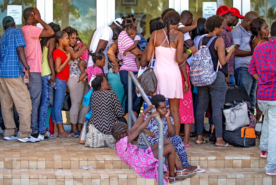 People wait to be processed and checked into a shelter in Nassau, Bahamas, for victims of Hurricane Dorian on Monday, Sept. 9, 2019.