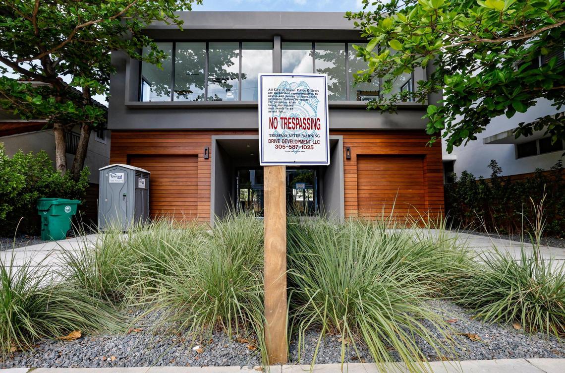 A no-trespassing sign sits in front of townhouses along Coconut Grove Avenue in the Grove built by Doug Cox, Feb. 9, 2023.