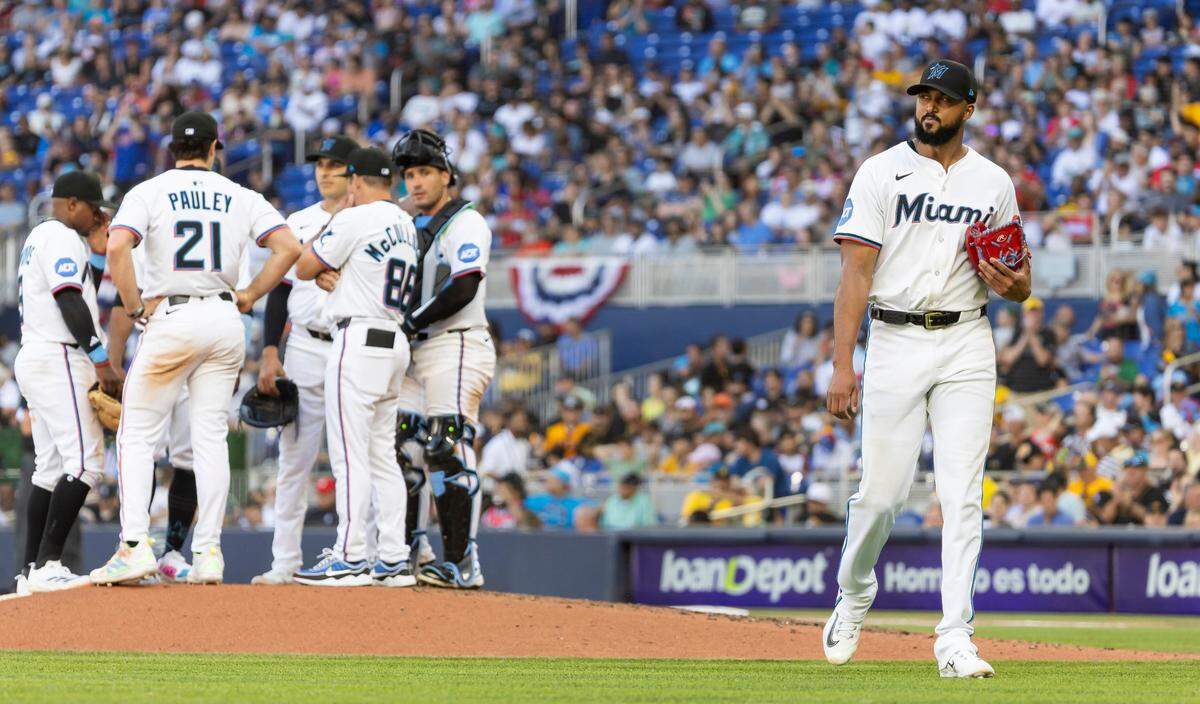 Miami Marlins pitcher Sandy Alcantara (22) leaves the mound after being relived by manager Clayton McCullough (86) in the fifth inning of their Opening Day MLB game against the Pittsburgh Pirates at loanDepot park on Thursday, March 27, 2025, in Miami, Fla.