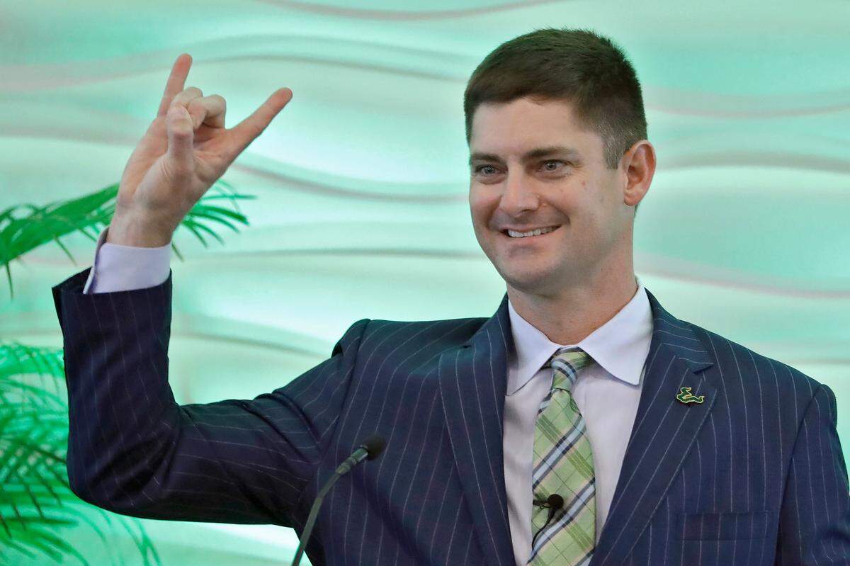 New South Florida NCAA college football head coach Jeff Scott gestures during an introductory news conference Wednesday, Dec. 11, 2019, in Tampa, Fla. Scott, the fifth head coach in USF history, was formerly co-offensive coordinator at Clemson.