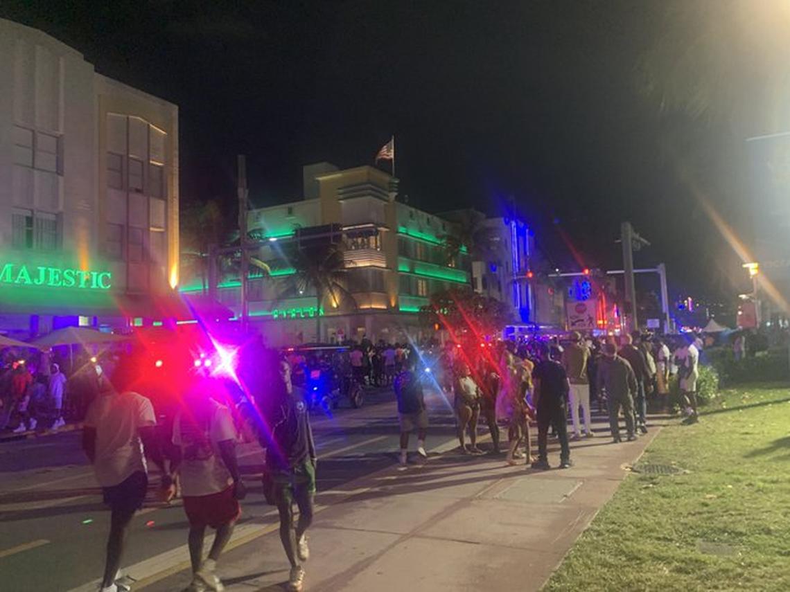 Police and pedestrians are seen walking along Ocean Drive on South Beach on Friday night, March 17, 2023.
