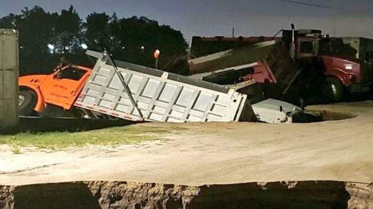 A truck recedes into the sunken earth on Boggy Creek Road outside Orlando.