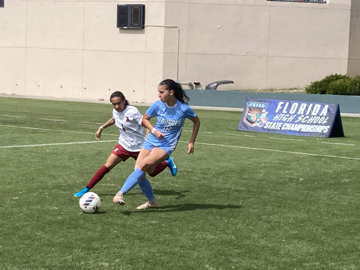 Lourdes’ Lily Martinez outdoes Innovation defender Jaslyn Mason for possession during Friday’s Class 5A state girls’ soccer semifinal at Spec Martin Stadium in DeLand, Fla.