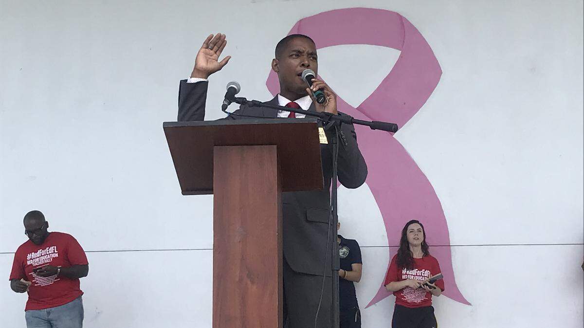 Cedric McMinn speaks during a rally in Miami Gardens Sunday for public school teachers. He’s hoping to become Florida’s first openly gay black lawmaker.