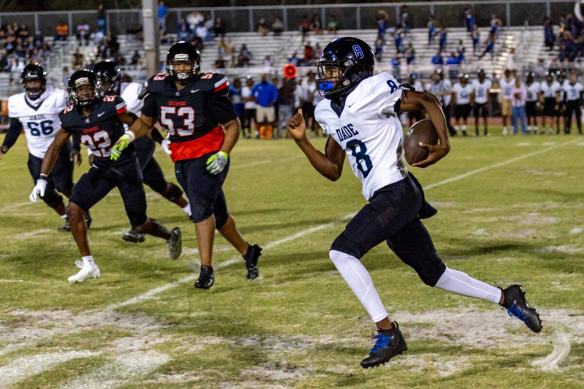 South Dade quarterback Jean Calixte (8) runs the ball during the first half of a high school football game against South Ridge at South Ridge Stadium in Miami, Florida, on Friday, November 3, 2023.