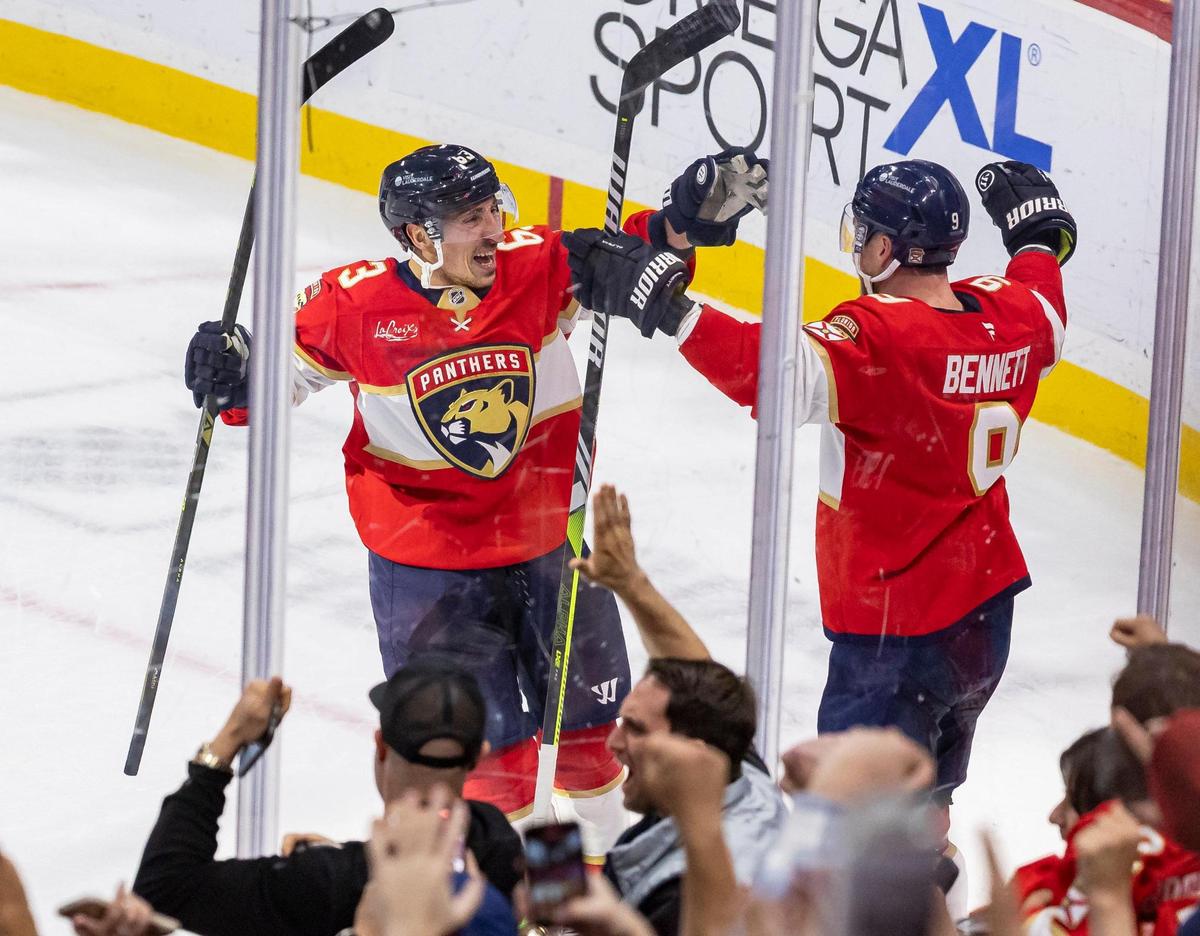 Florida Panthers centers Sam Bennett (9) and Brad Marchand (63) celebrate after scoring against Utah Hockey Club goaltender Karel Vejmelka (70) in the overtime period of their NHL game at Amerant Bank Arena on Friday, March 28, 2025, in Sunrise, Fla.