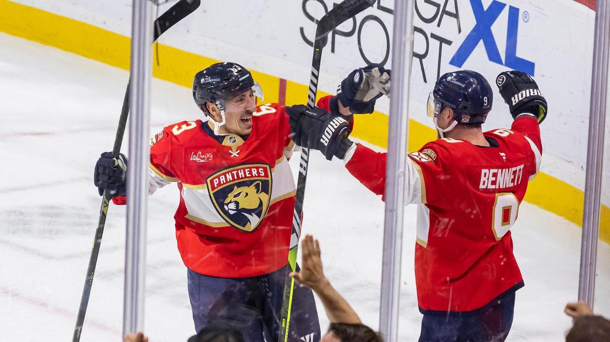Florida Panthers centers Sam Bennett (9) and Brad Marchand (63) celebrate after scoring against Utah Hockey Club goaltender Karel Vejmelka (70) in the overtime period of their NHL game at Amerant Bank Arena on Friday, March 28, 2025, in Sunrise, Fla.