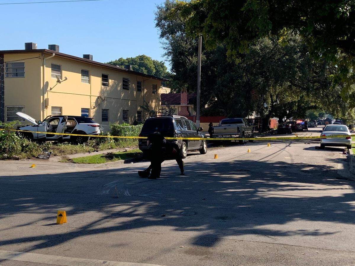 Miami police believe the white Range Rover, in the apartment building yard to the left, smashed into the red Nissan, the rear of which can be seen in the shade on the left side of Northwest 11th Avenue.