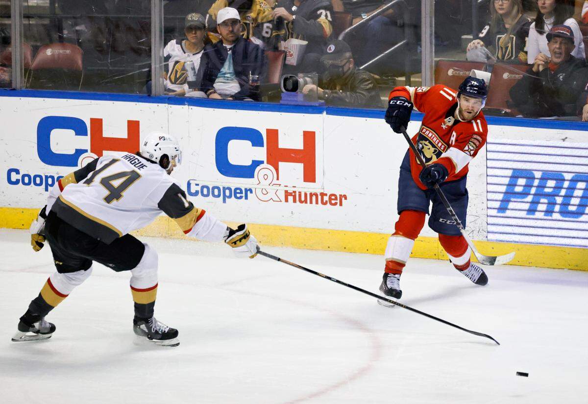 Florida Panthers left wing Jonathan Huberdeau (11) passes the puck against Vegas Golden Knights defenseman Nicolas Hague (14) during the third period of an NHL game at the FLA Live Arena on Thursday, January 27, 2022 in Sunrise, Fl.