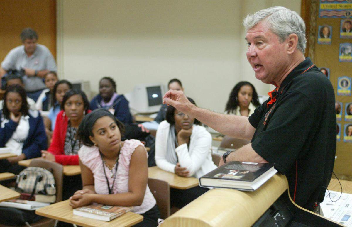 In this file photo from Sept. 17, 2004, U.S. Sen. Bob Graham teaches an Advanced Placement Government class at Miami Carol City Senior High School. His 400th workday was back at the school where he started his workdays in the 1970s.