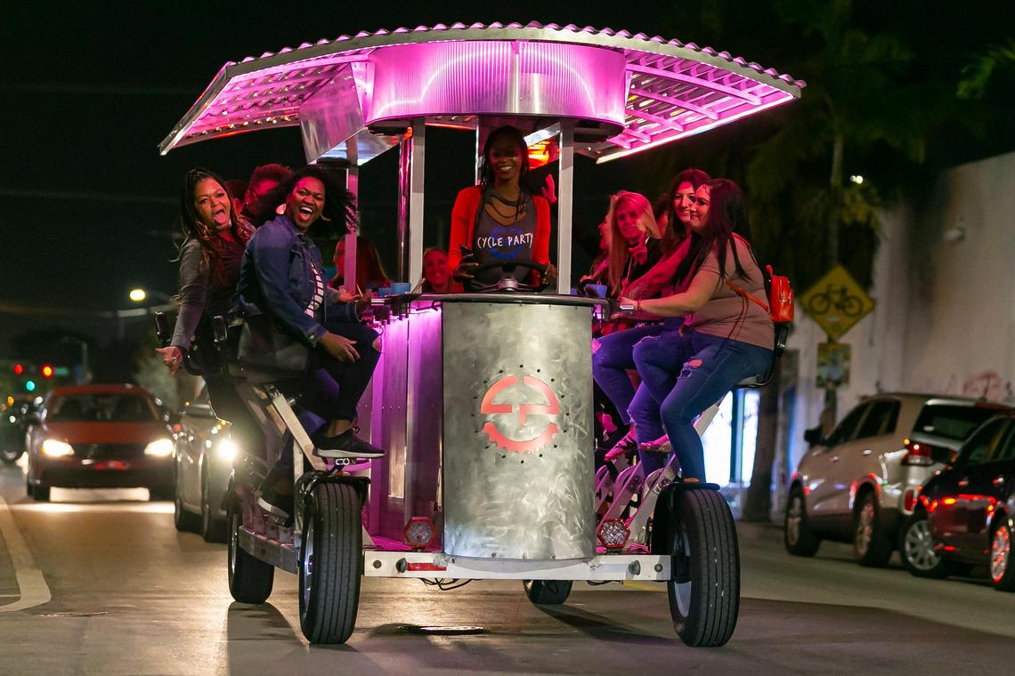 Guests ride onboard the Cycle Party as they drink and tour through Miami’s Wynwood district on a recent Friday night.