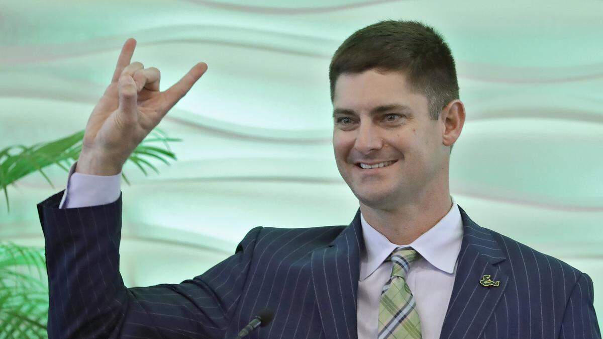 New South Florida NCAA college football head coach Jeff Scott gestures during an introductory news conference Wednesday, Dec. 11, 2019, in Tampa, Fla. Scott, the fifth head coach in USF history, was formerly co-offensive coordinator at Clemson.