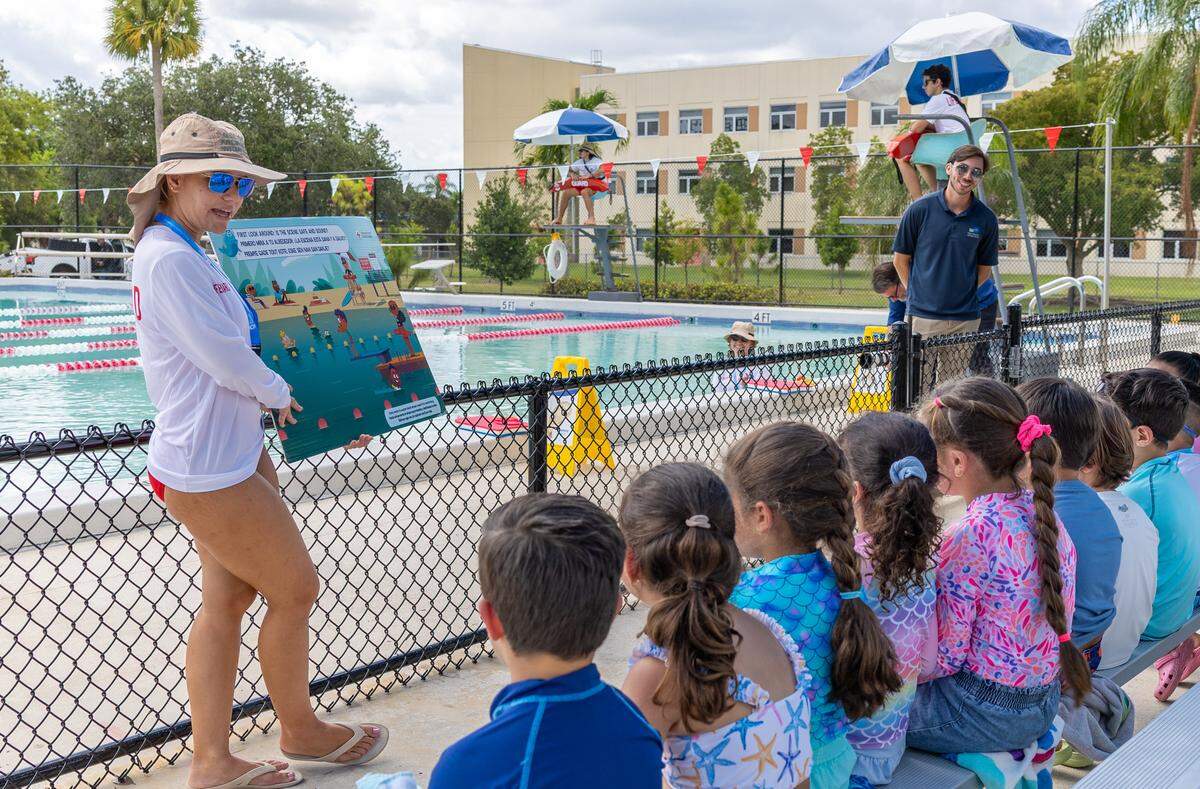 Yara Sanchez, 21, a Miami-Dade county life guard, instructs a group of kindergarteners from Rockway Elementary School on water safety at Rockway Park Swimming Pool on Thursday, May 14, 2026, in Miami, Fla. The students are participants in Miami-Dade County's Zero Drowning initiative that aims to reduce children drowning.