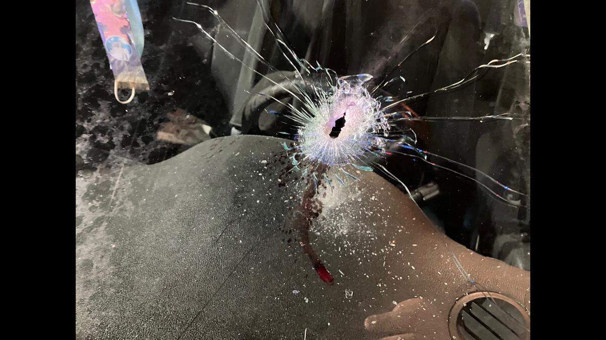 The hole in the Nissan Altima’s windshield that the driver says came from a shot fired out of a black Mercedes on Interstate 95.
