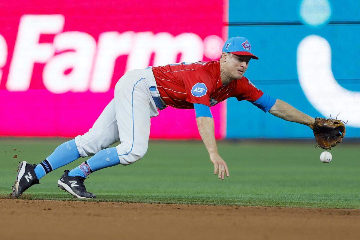 Apr 1, 2023; Miami, Florida, USA; Miami Marlins shortstop Joey Wendle (18) dives but cannot catch a base hit from New York Mets catcher Omar Narvaez (not pictured) during the eighth inning at loanDepot Park. Mandatory Credit: Sam Navarro-USA TODAY Sports