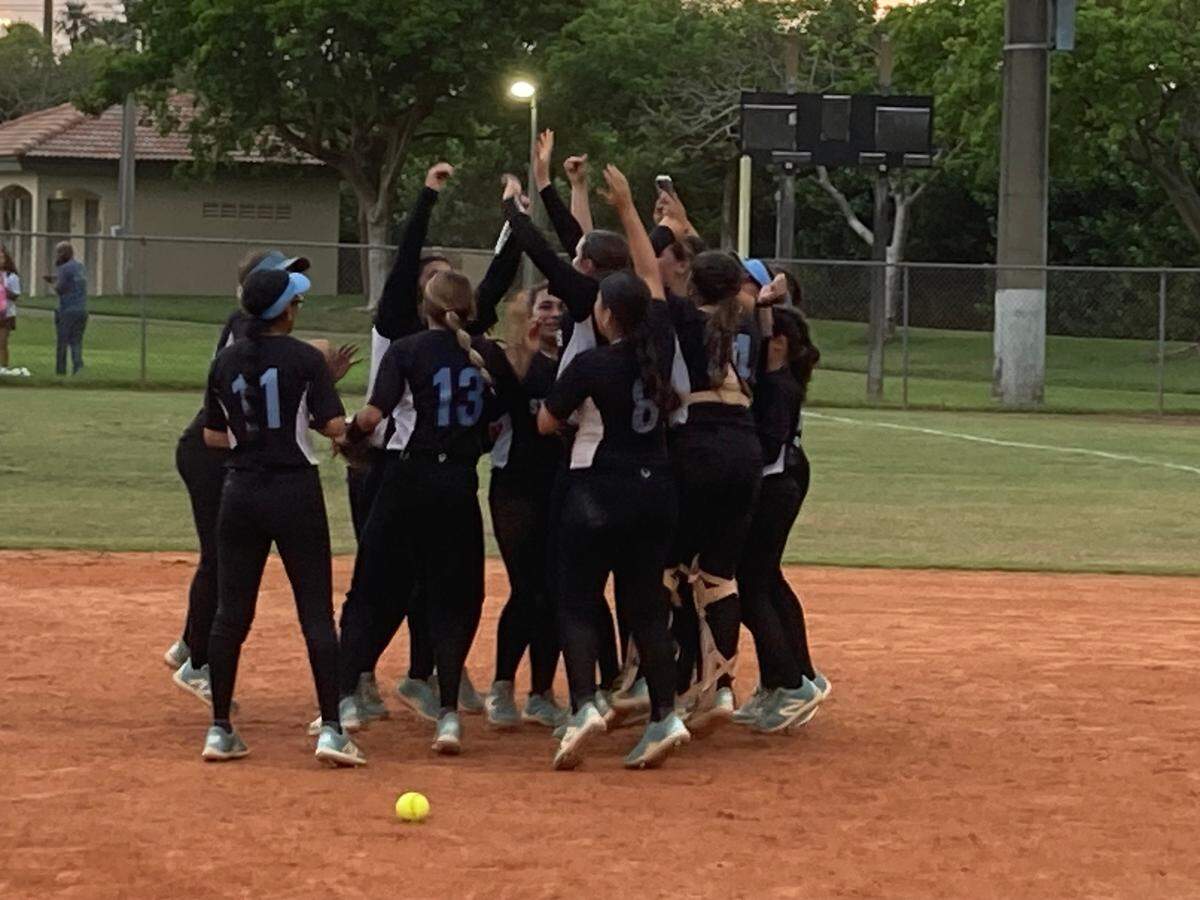 The Somerset Silver Palms softball team celebrates on the field after upsetting Coral Springs Charter to return to the state final four for the second consecutive season.
