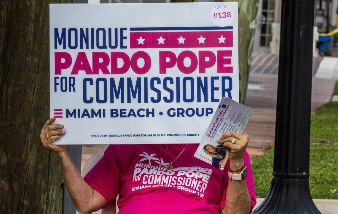 A campaign worker for the commission candidate Monica Pardo Pope, holds a sing during the Election Day on November 4, City of Miami Beach general municipal and special elections, outside of the South Point Elementary School voting poll location, on November 4, 2025.