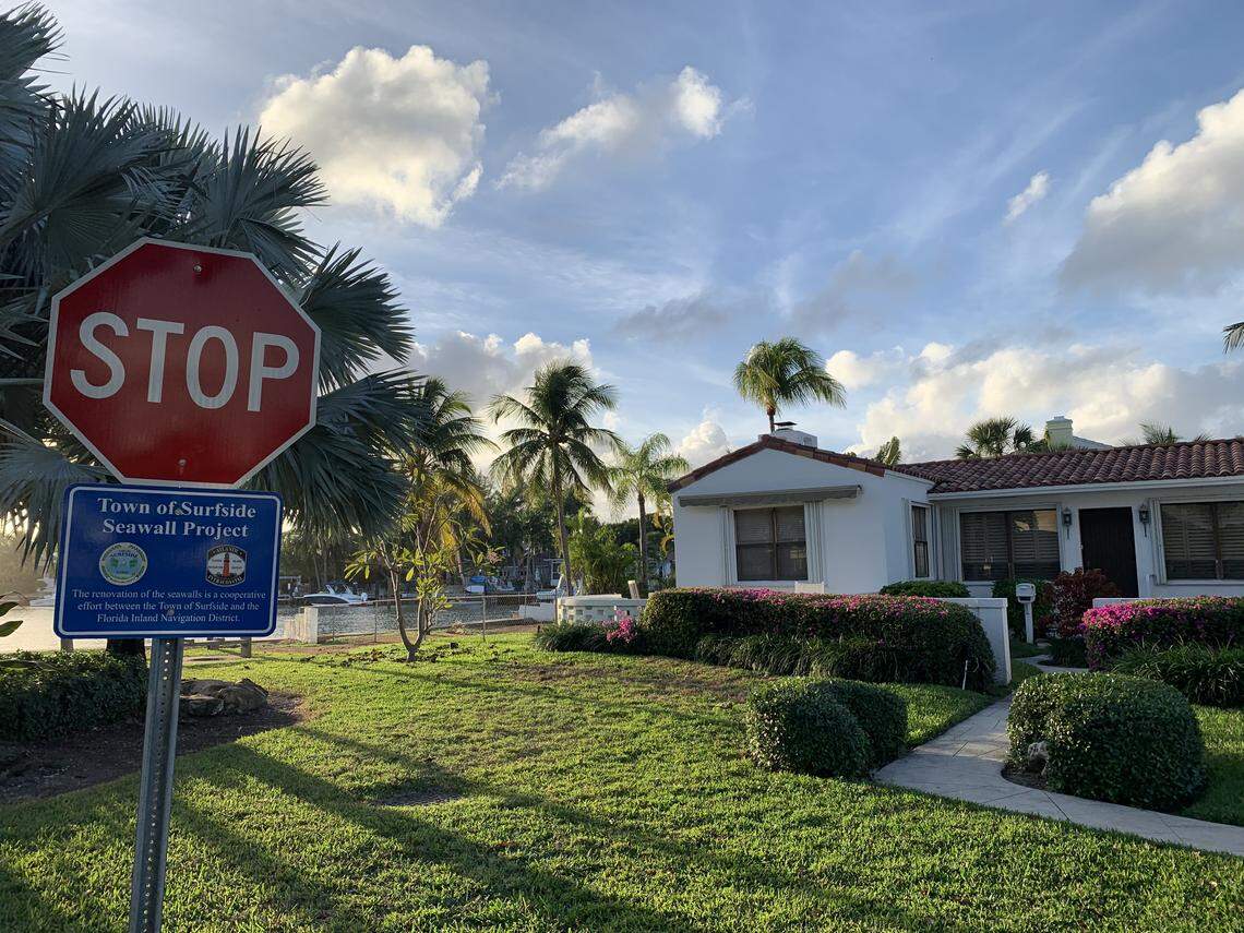 A sign in the public space next to 81-year-old Daryle Prager’s home says the city of Surfside elevated the seawall there. Prager says they haven’t, and she doesn’t have much time before the rising water reaches her home.