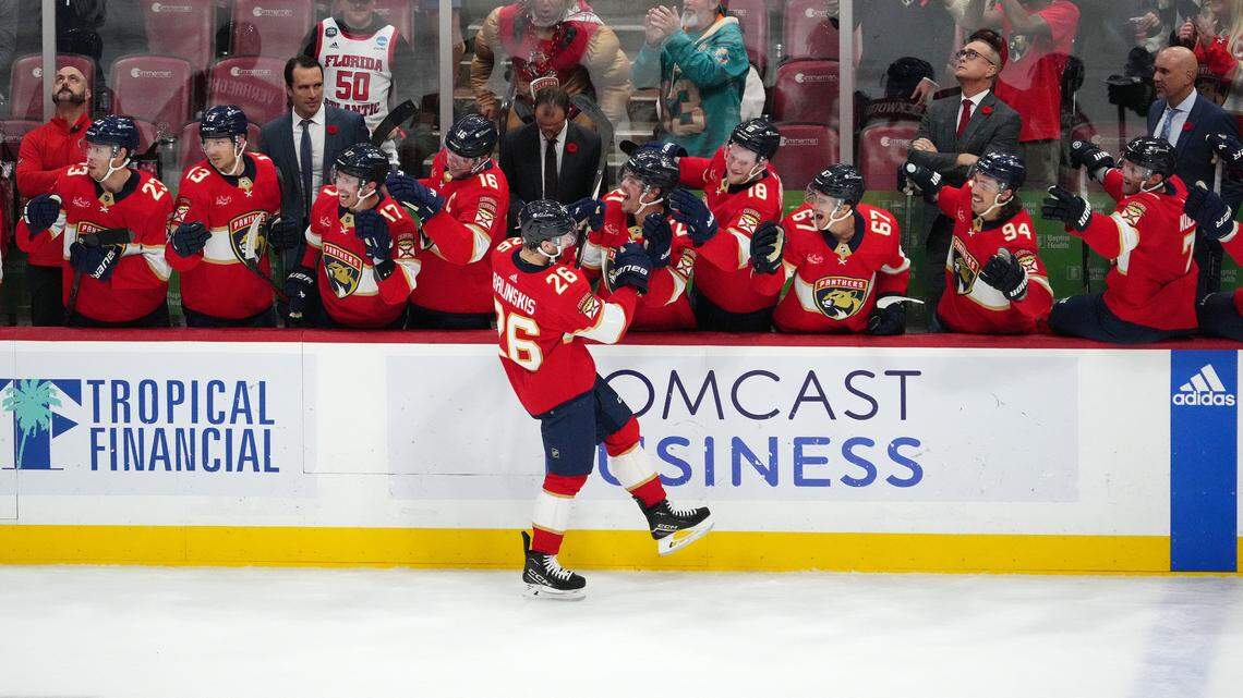 Nov 10, 2023; Sunrise, Florida, USA; Florida Panthers defenseman Uvis Balinskis (26) celebrates with teammates after scoring a goal against the Carolina Hurricanes during the first period at Amerant Bank Arena.