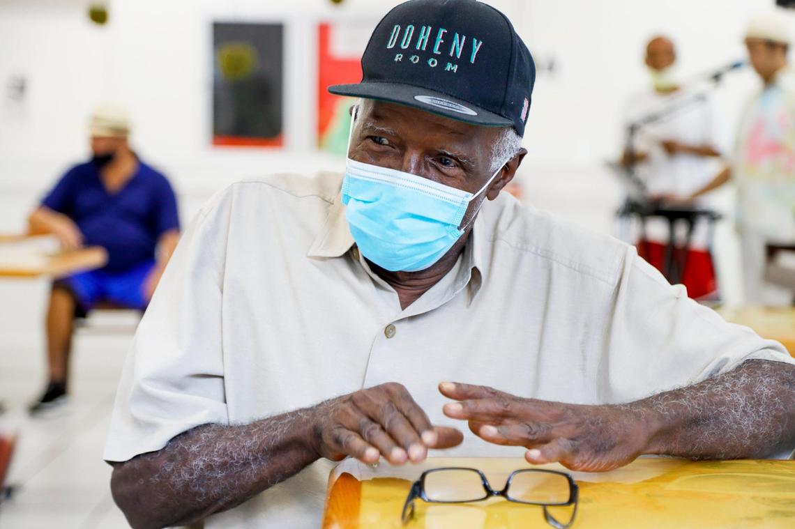 Giraldo Hernandez, 72, enjoys live salsa music by tapping a dining table at Mia Casa, the former assisted living facilty in North Miami that the Homeless Trust has rented out to house homeless seniors in Miami-Dade.