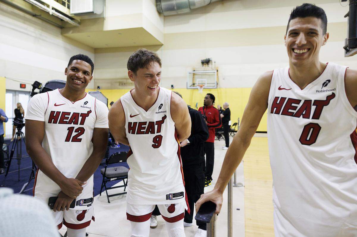 Dru Smith (12), Pelle Larsson (9) and Simone Fontecchio (0) joke around while they wait to be interviewed during the Miami Heat Media Day on Sept. 29, 2025, at Kaseya Center in Miami.