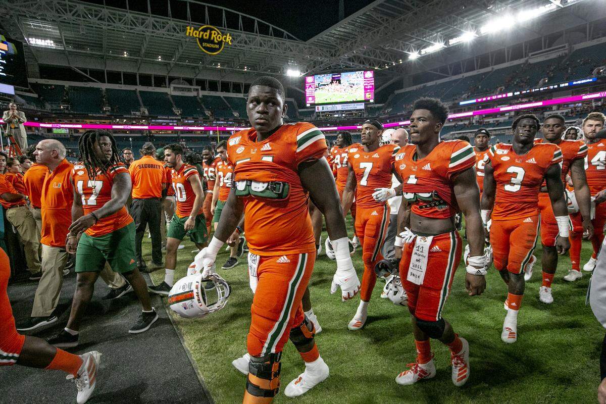 Miami Hurricanes offensive lineman John Campbell Jr. (74), at center, walks off the field after Miami is defeated by Virginia Tech at Hard Rock Stadium on Saturday, October 5, 2019.