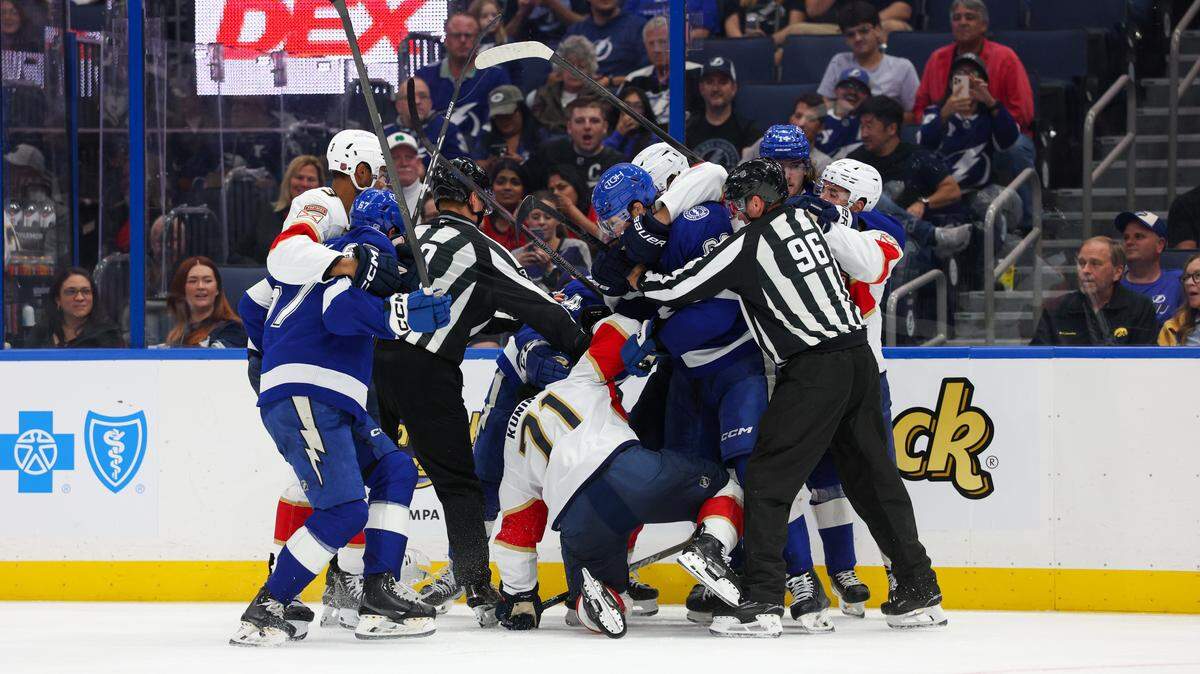 Oct 2, 2025; Tampa, Florida, USA; Florida Panthers center Luke Kunin (71) and Tampa Bay Lightning center Jack Finley (62) lock up in the third period at Benchmark International Arena. Mandatory Credit: Nathan Ray Seebeck-Imagn Images