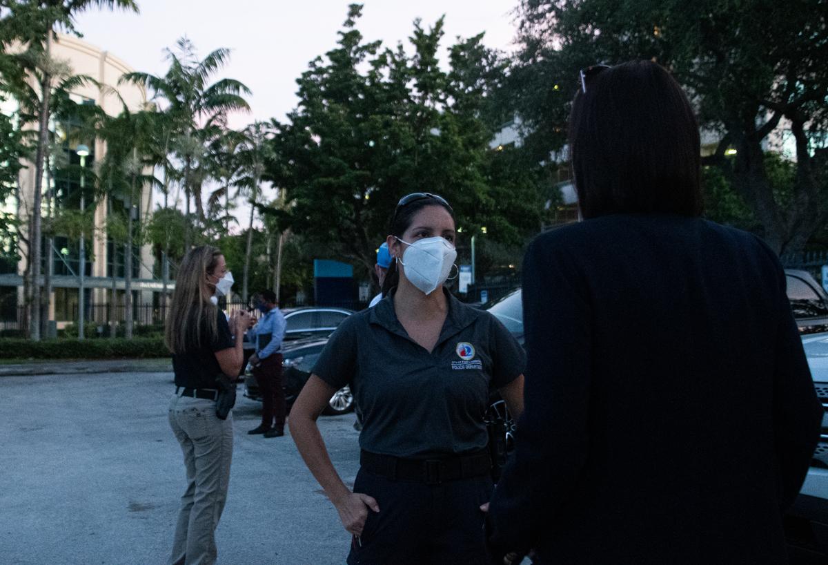 Traffic Homicide Investigator Andrea Johnson talks to the sister of hit-and-run victim Lynn Hessley, who suffered multiple injuries after being struck by a white Ford Mustang on State Road A1A in Fort Lauderdale on July 3, 2020.