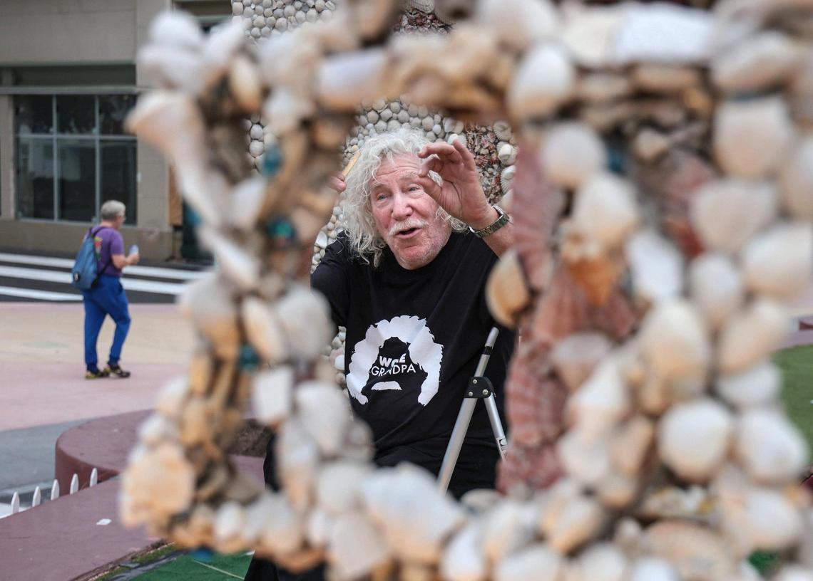 Roger Abramson recalls why he created a menorah and dreidel out of seashells 20 years ago and it’s still used to celebrate Hanukkah on Lincoln Road. On Nov. 18, Abramson, 87, climbed on a ladder to fix shells that have fallen off.